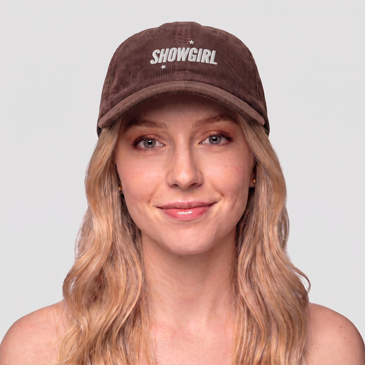Model wearing a brown Taylor Swift inspired Showgirl cap – embroidered corduroy hat for Swifties, vintage concert-style accessory with bold lettering