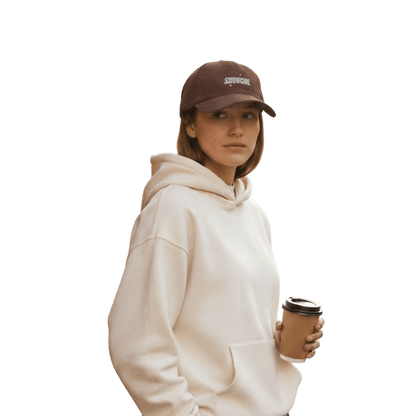 Model wearing a brown Taylor Swift inspired Showgirl cap – embroidered corduroy hat for Swifties, vintage concert-style accessory with bold lettering