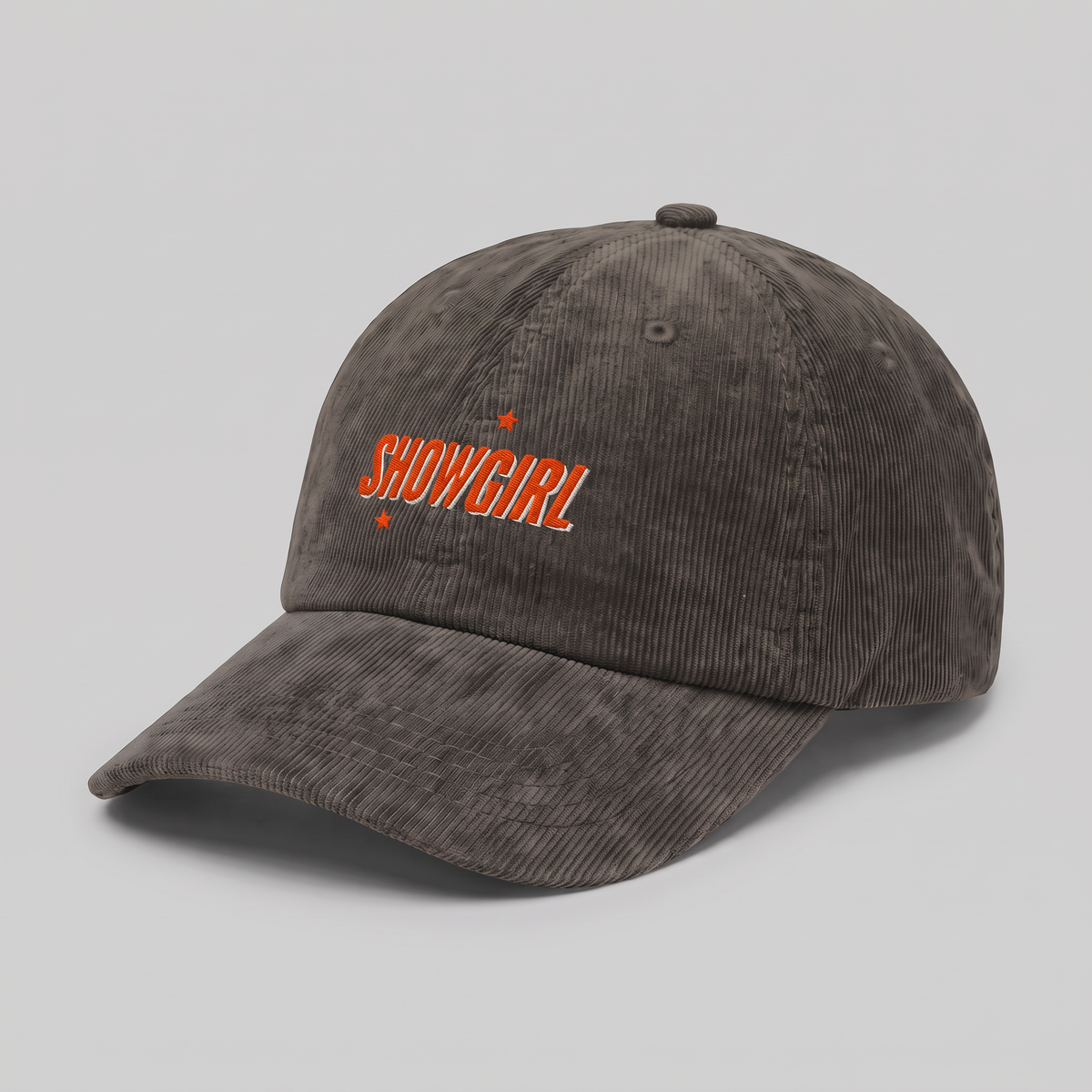 An olive corduroy baseball cap with 'SHOWGIRL' embroidered in orange on the front, accented by two small orange stars, shown on a plain white background.