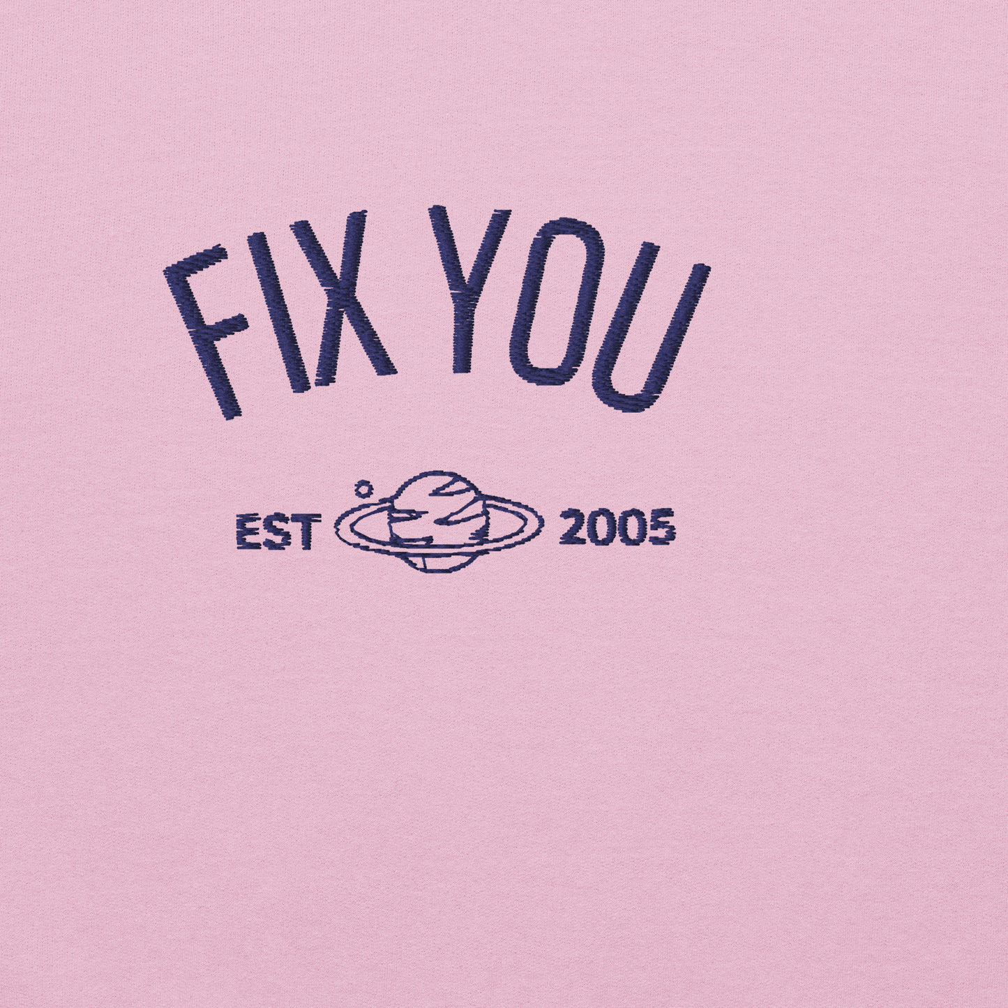 Pink minimalist crewneck featuring blue “Fix You” typography with subtle graphic detail - Coldplay inspired band merch, aesthetic Coldplay “Fix You” song fan apparel
