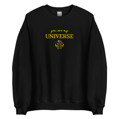 Black crewneck sweatshirt featuring yellow typography that reads “you are my Universe” with minimalist hands holding stars illustration -inspired by Coldplay’s hit song “My Universe”, aesthetic fan apparel for music lovers.