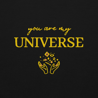 Black crewneck sweatshirt featuring yellow typography that reads “you are my Universe” with minimalist hands holding stars illustration -inspired by Coldplay’s hit song “My Universe”, aesthetic fan apparel for music lovers.