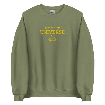 Green crewneck sweatshirt featuring yellow typography that reads “you are my Universe” with minimalist hands holding stars illustration -inspired by Coldplay’s hit song “My Universe”, aesthetic fan apparel for music lovers.