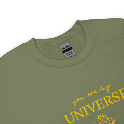Green crewneck sweatshirt featuring yellow typography that reads “you are my Universe” with minimalist hands holding stars illustration -inspired by Coldplay’s hit song “My Universe”, aesthetic fan apparel for music lovers.