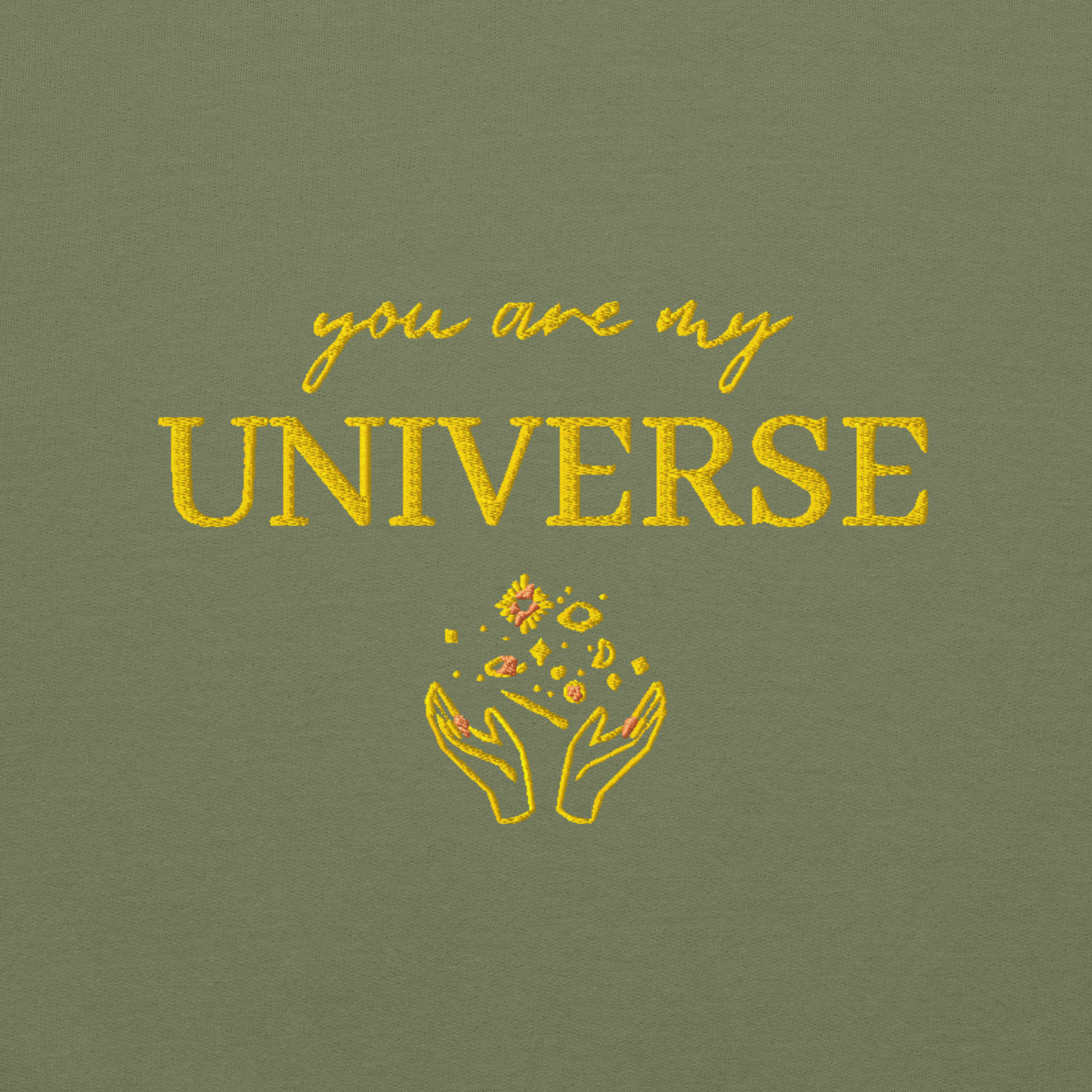 Green crewneck sweatshirt featuring yellow typography that reads “you are my Universe” with minimalist hands holding stars illustration -inspired by Coldplay’s hit song “My Universe”, aesthetic fan apparel for music lovers.