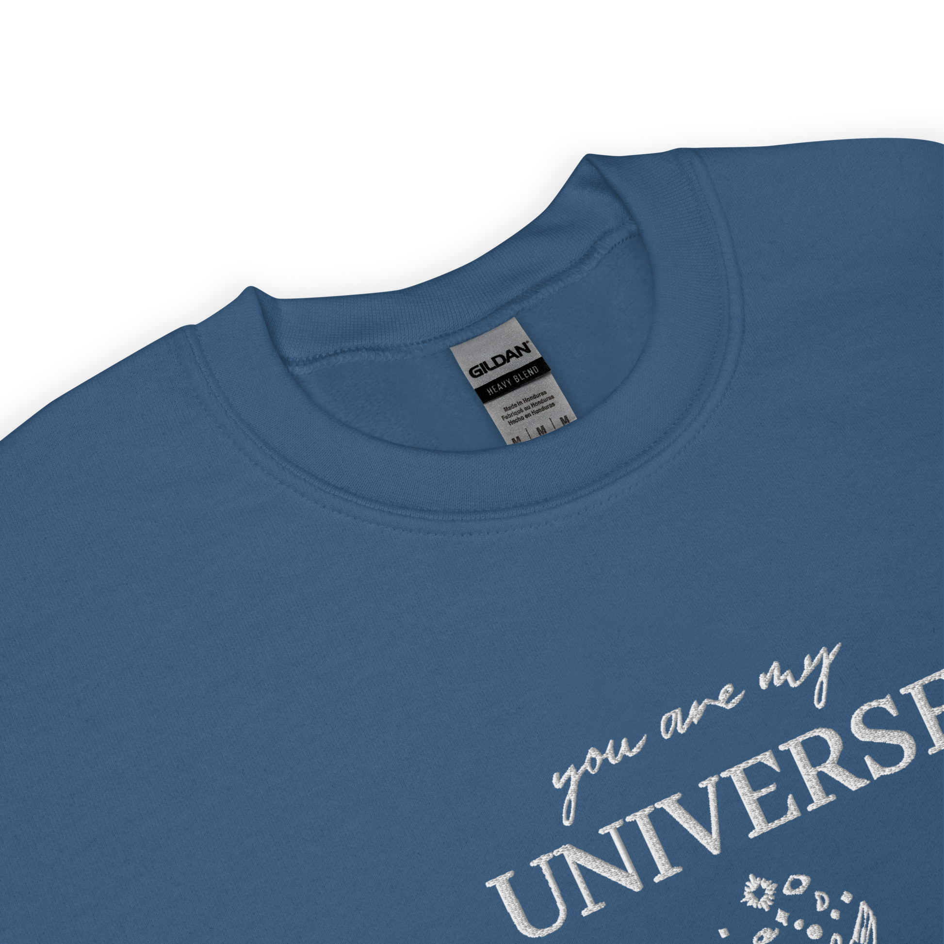 Indigo blue crewneck sweatshirt featuring white typography that reads “you are my Universe” with minimalist hands holding stars illustration -inspired by Coldplay’s hit song “My Universe”, aesthetic fan apparel for music lovers.