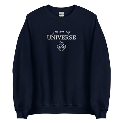 Navy crewneck sweatshirt featuring white typography that reads “you are my Universe” with minimalist hands holding stars illustration -inspired by Coldplay’s hit song “My Universe”, aesthetic fan apparel for music lovers.