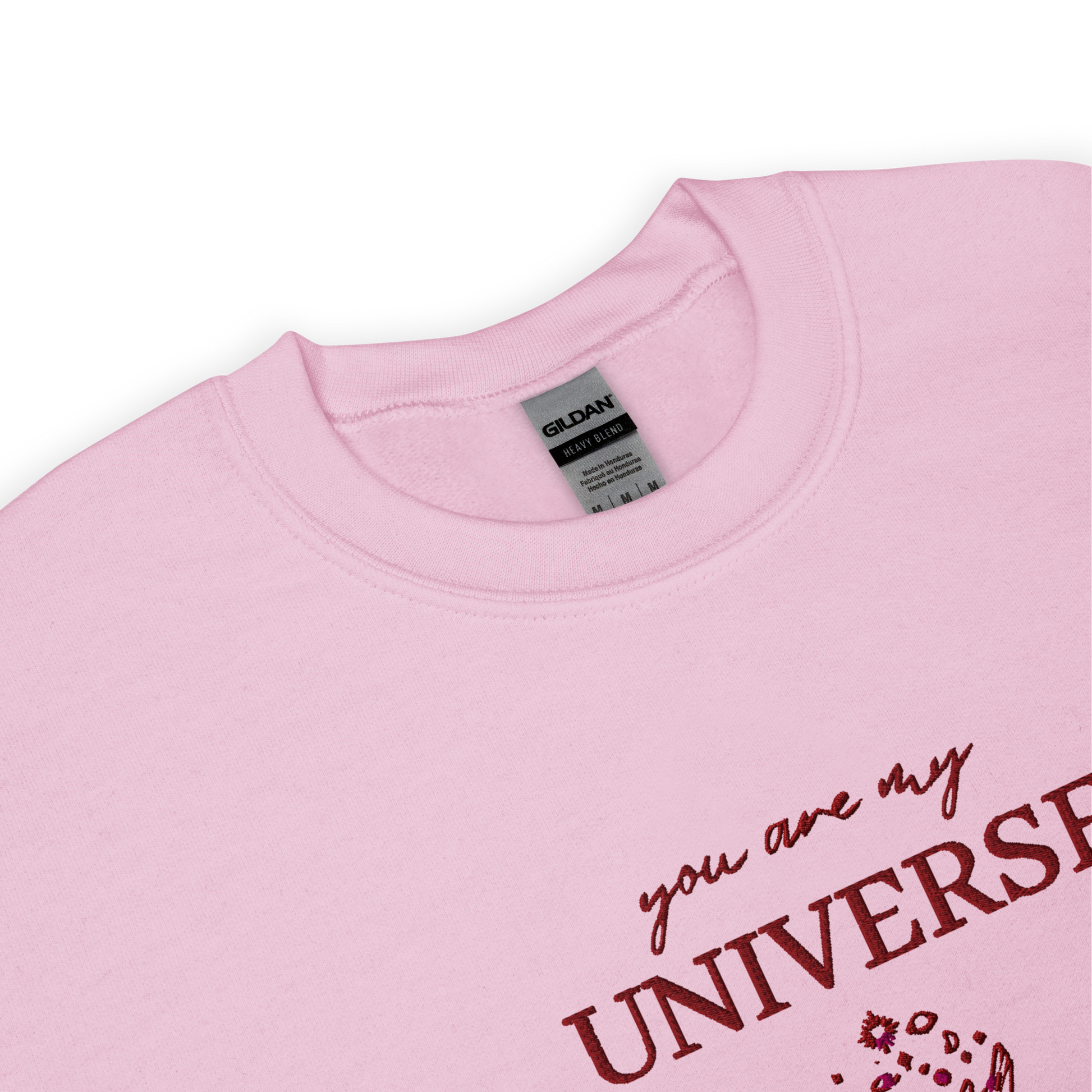 Pink crewneck sweatshirt featuring maroon typography that reads “you are my Universe” with minimalist hands holding stars illustration -inspired by Coldplay’s hit song “My Universe”, aesthetic fan apparel for music lovers.