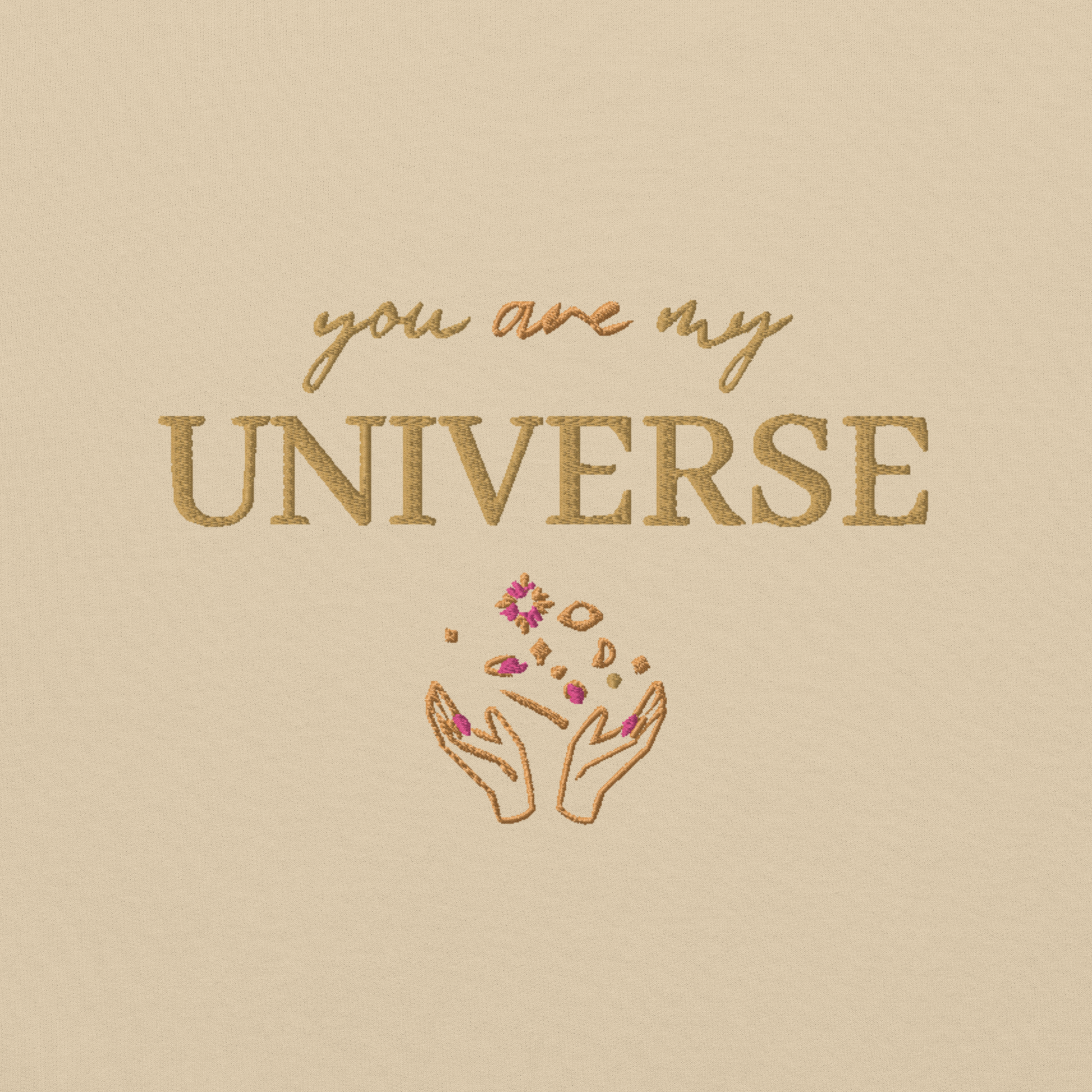 Sand crewneck sweatshirt featuring yellow typography that reads “you are my Universe” with minimalist hands holding stars illustration -inspired by Coldplay’s hit song “My Universe”, aesthetic fan apparel for music lovers 