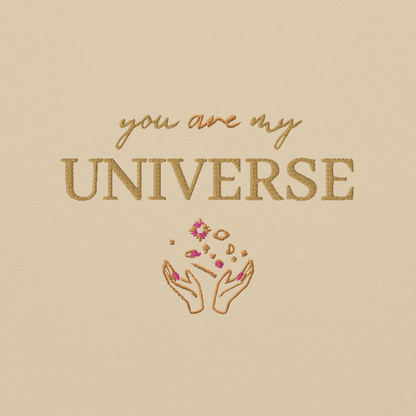 Sand crewneck sweatshirt featuring yellow typography that reads “you are my Universe” with minimalist hands holding stars illustration -inspired by Coldplay’s hit song “My Universe”, aesthetic fan apparel for music lovers 