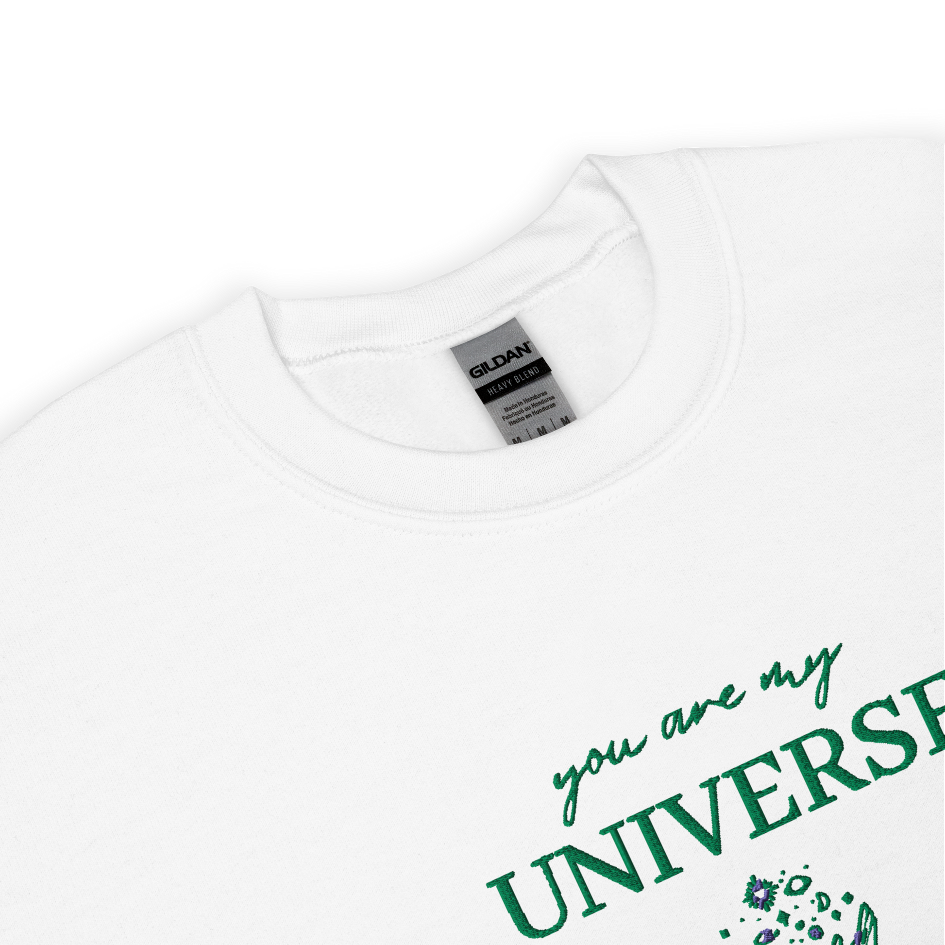 White crewneck sweatshirt featuring green typography that reads “you are my Universe” with minimalist hands holding stars illustration -inspired by Coldplay’s hit song “My Universe”, aesthetic fan apparel for music lovers.
