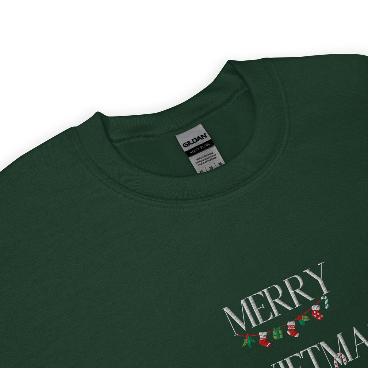 Green sweatshirt, close-up view of "Merry Swiftmas" embroidered text with a stocking garland and candy cane, holiday Taylor Swift design