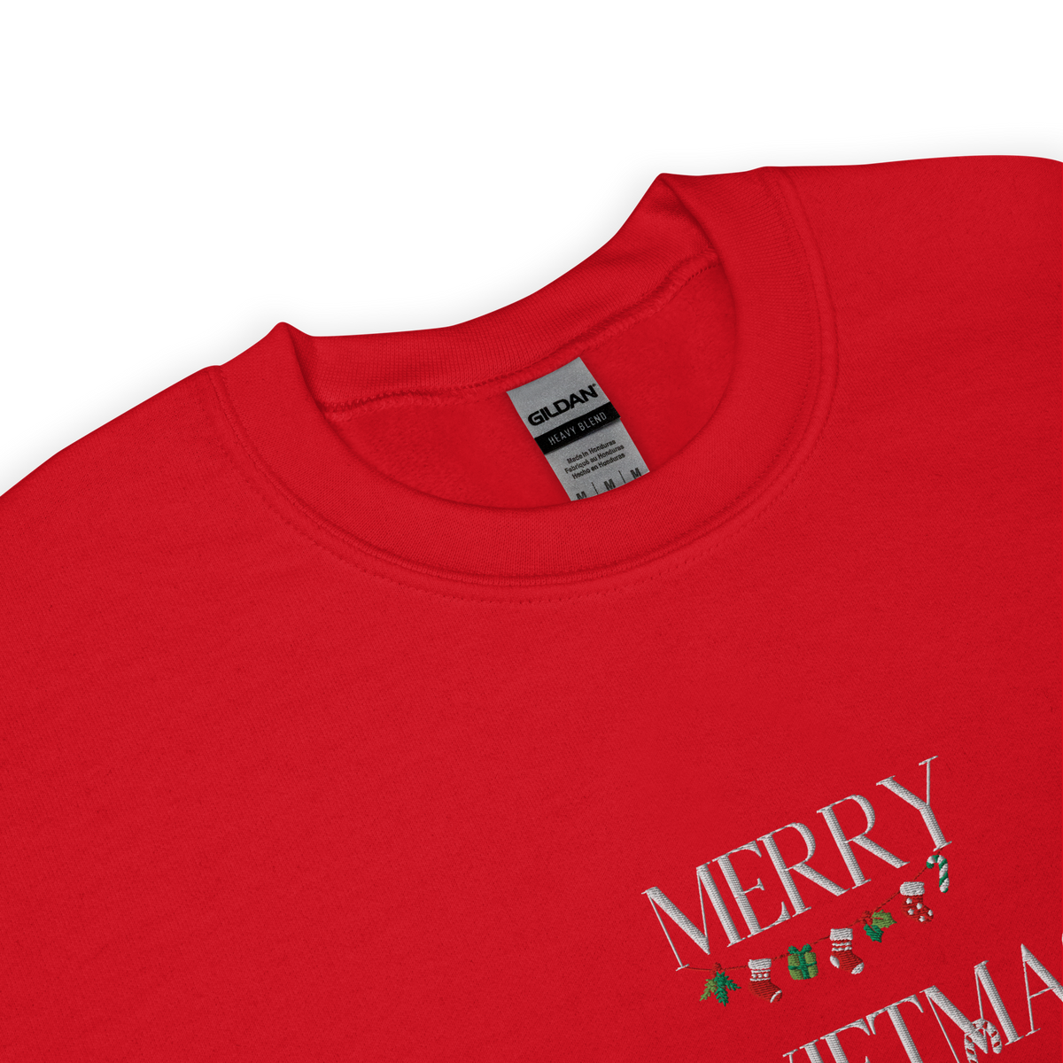 Red sweatshirt, close-up view of "Merry Swiftmas" embroidered text with a stocking garland and candy cane, holiday Taylor Swift design