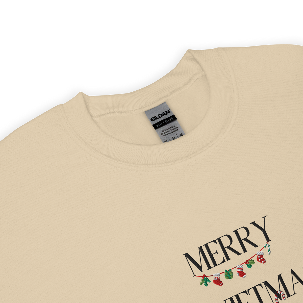 Sand sweatshirt, close-up view of "Merry Swiftmas" embroidered text with a stocking garland and candy cane, holiday Taylor Swift design