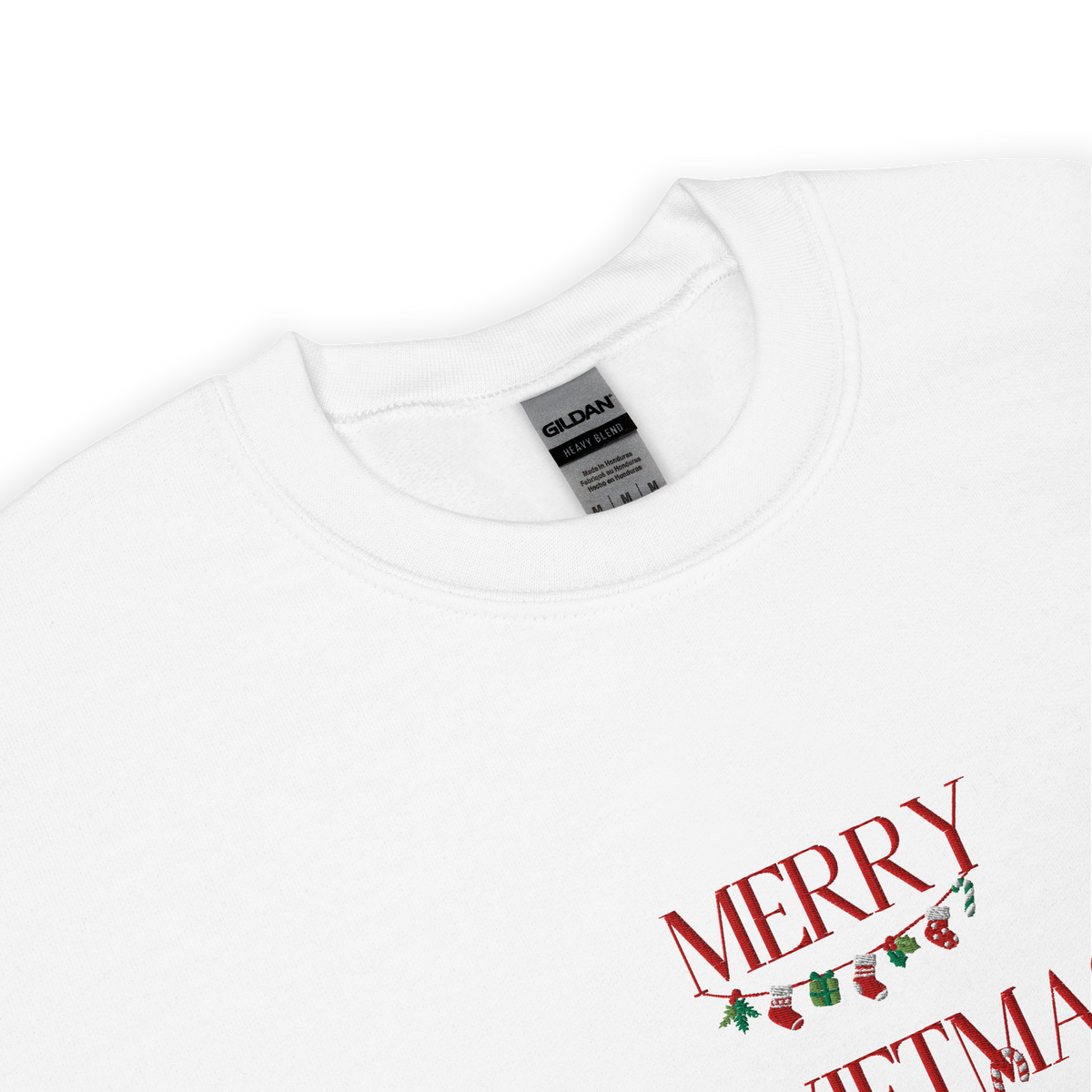 White sweatshirt, close-up view of "Merry Swiftmas" embroidered text with a stocking garland and candy cane, holiday Taylor Swift design