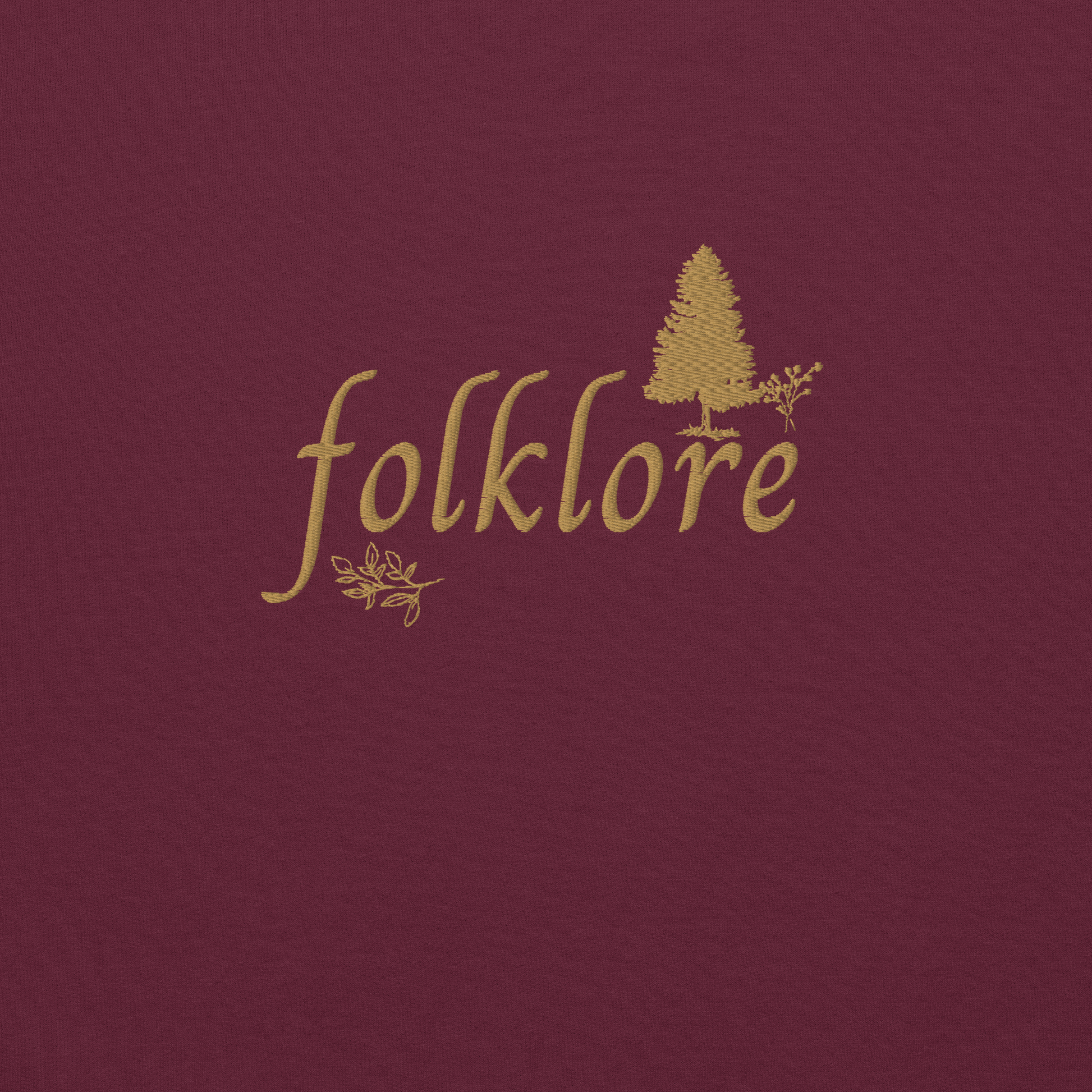 Maroon folklore sweatshirt inspired by Taylor Swift’s folklore era, featuring minimalist gold ‘folklore’ lettering and tree graphic on a cozy crewneck pullover, aesthetic indie music merch