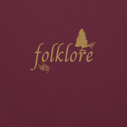 Maroon folklore sweatshirt inspired by Taylor Swift’s folklore era, featuring minimalist gold ‘folklore’ lettering and tree graphic on a cozy crewneck pullover, aesthetic indie music merch