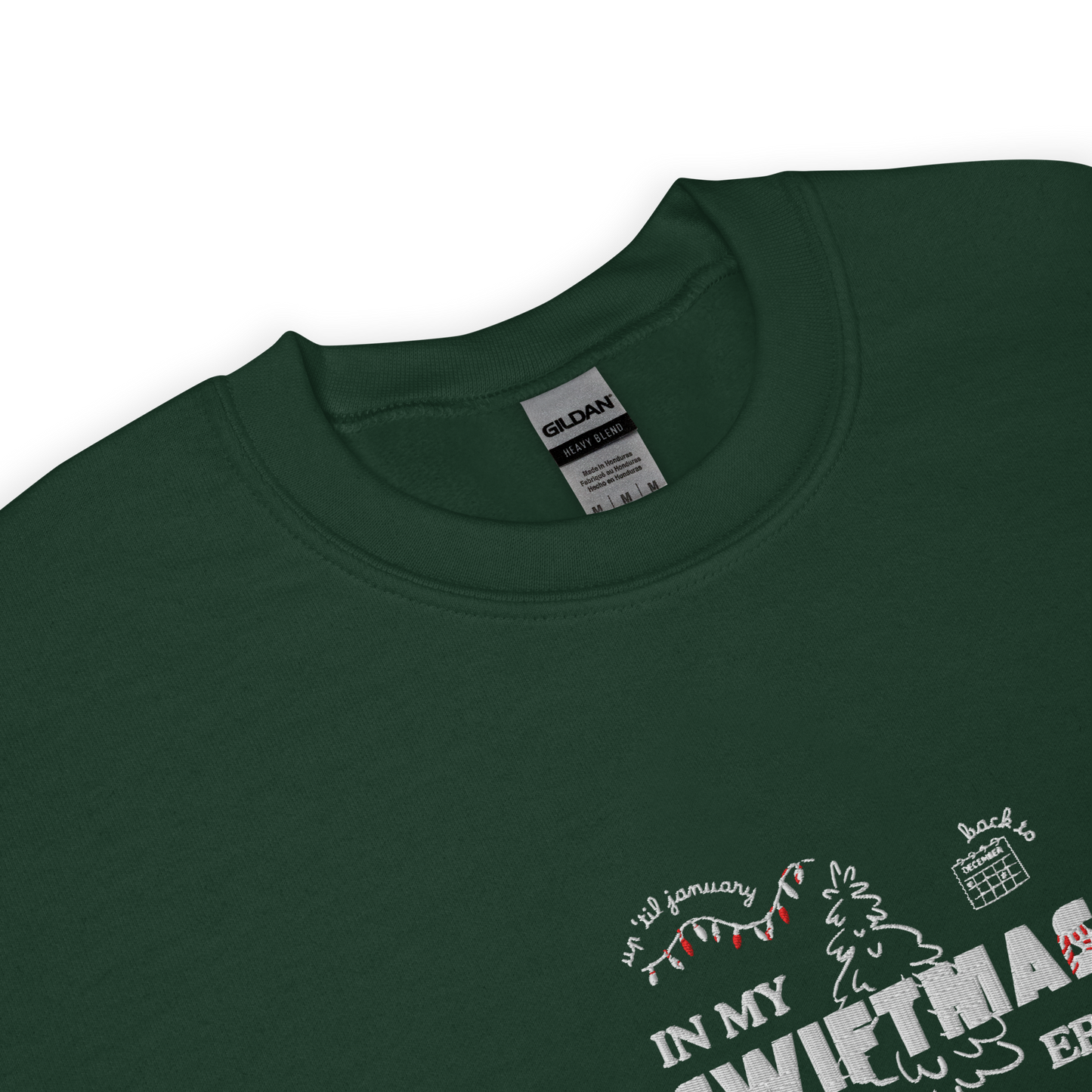 Forest green sweatshirt with red “In My Swiftmas Era” graphic featuring festive Christmas doodles, Taylor Swift inspired holiday sweatshirt for Swiftie fans