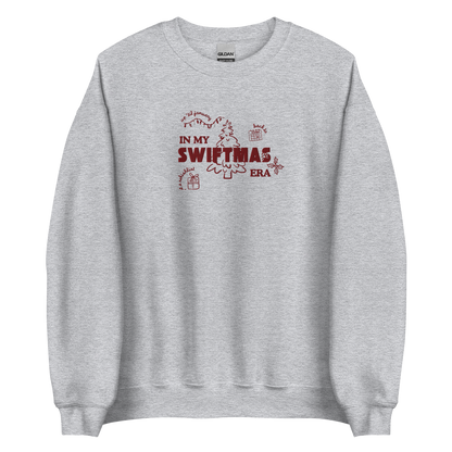 Grey sweatshirt with red “In My Swiftmas Era” graphic featuring festive Christmas doodles, Taylor Swift inspired holiday sweatshirt for Swiftie fans