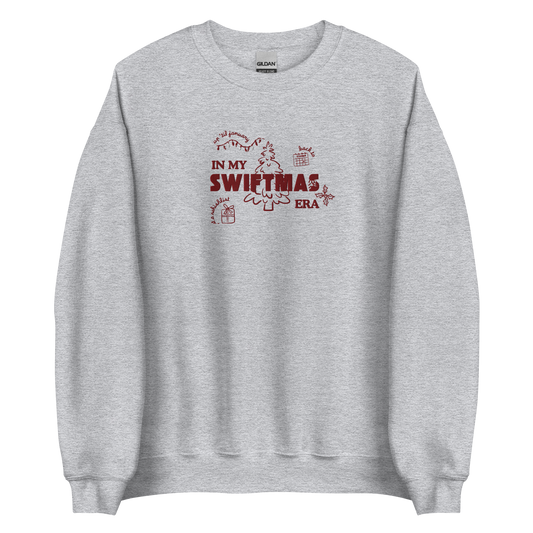 Grey sweatshirt with red “In My Swiftmas Era” graphic featuring festive Christmas doodles, Taylor Swift inspired holiday sweatshirt for Swiftie fans