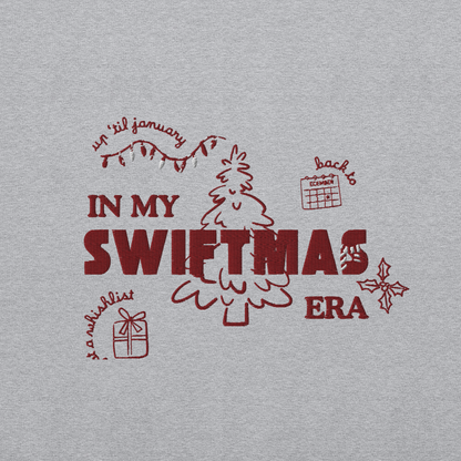 Grey sweatshirt with red “In My Swiftmas Era” graphic featuring festive Christmas doodles, Taylor Swift inspired holiday sweatshirt for Swiftie fans