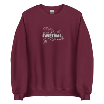 Maroon sweatshirt with red “In My Swiftmas Era” graphic featuring festive Christmas doodles, Taylor Swift inspired holiday sweatshirt for Swiftie fans