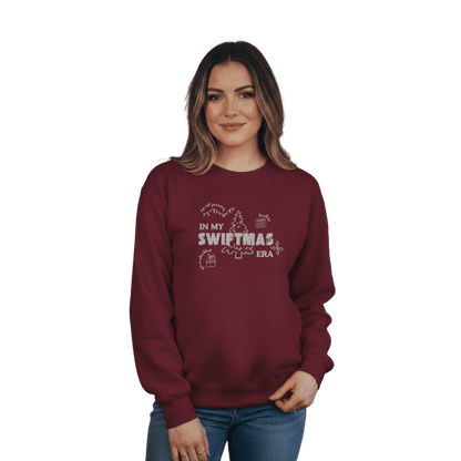 Maroon sweatshirt with red “In My Swiftmas Era” graphic featuring festive Christmas doodles, Taylor Swift inspired holiday sweatshirt for Swiftie fans