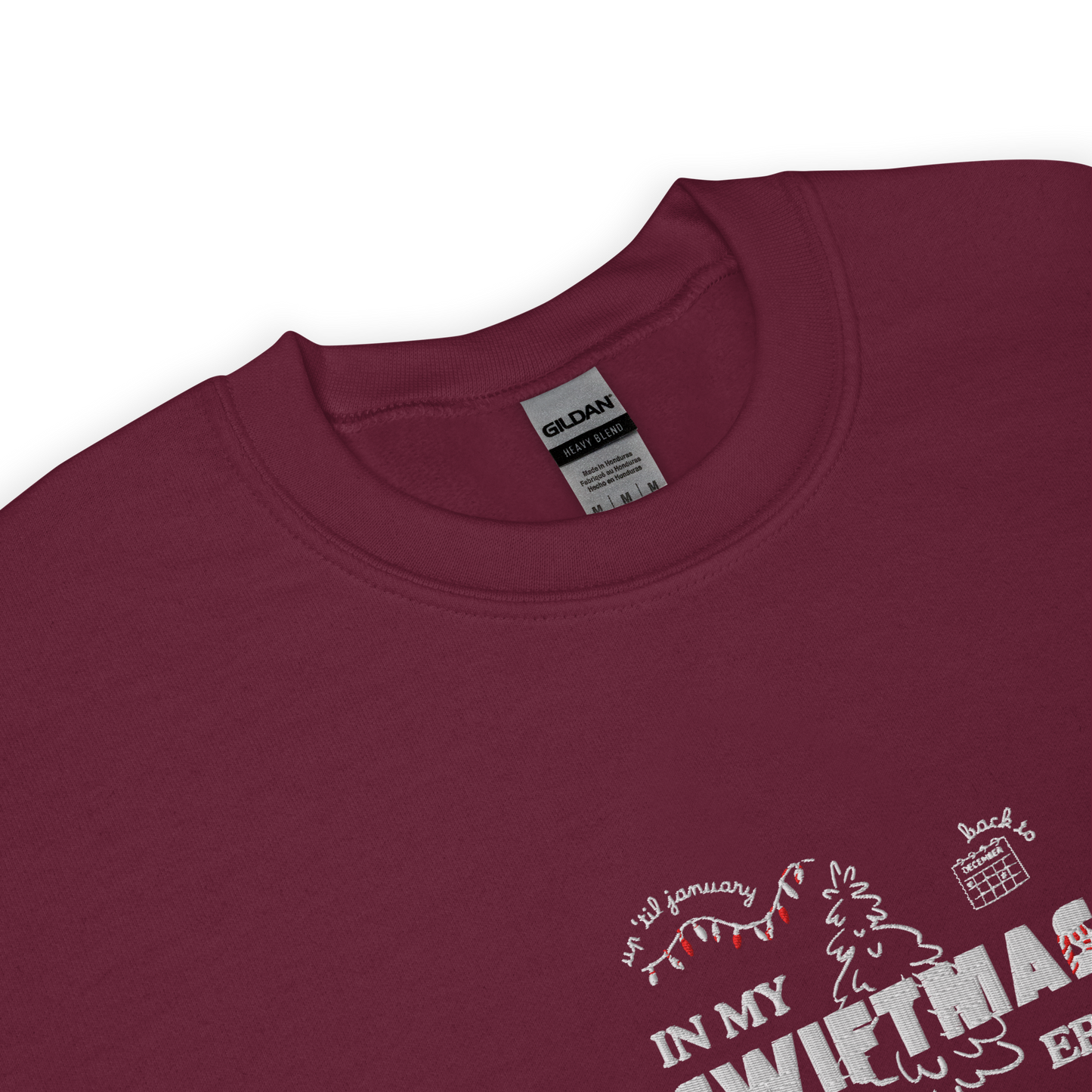 Maroon sweatshirt with red “In My Swiftmas Era” graphic featuring festive Christmas doodles, Taylor Swift inspired holiday sweatshirt for Swiftie fans