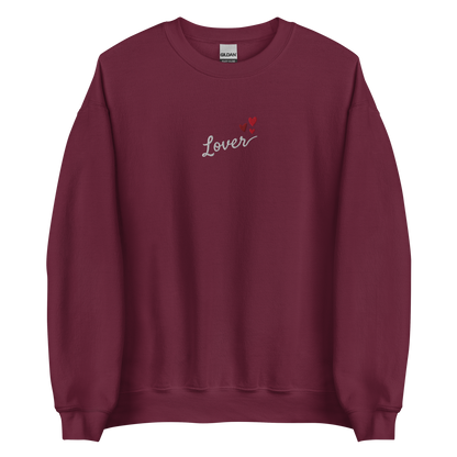 Maroon Lover sweatshirt inspired by Taylor Swift’s Lover era, featuring minimalist ‘Lover’ text with small heart details on a cozy pastel crewneck, soft romantic pop aesthetic merch