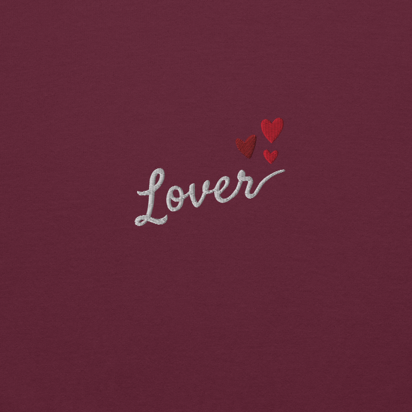 Maroon Lover sweatshirt inspired by Taylor Swift’s Lover era, featuring minimalist ‘Lover’ text with small heart details on a cozy pastel crewneck, soft romantic pop aesthetic merch