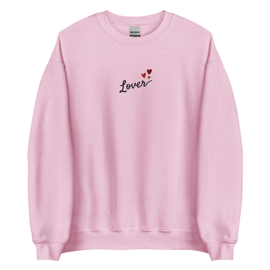 Light pink Lover sweatshirt inspired by Taylor Swift’s Lover era, featuring minimalist ‘Lover’ text with small heart details on a cozy pastel crewneck, soft romantic pop aesthetic merch