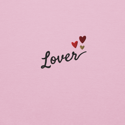 Light pink Lover sweatshirt inspired by Taylor Swift’s Lover era, featuring minimalist ‘Lover’ text with small heart details on a cozy pastel crewneck, soft romantic pop aesthetic merch