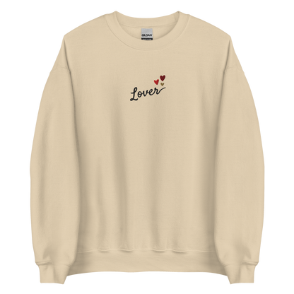 Sand Lover sweatshirt inspired by Taylor Swift’s Lover era, featuring minimalist ‘Lover’ text with small heart details on a cozy pastel crewneck, soft romantic pop aesthetic merch