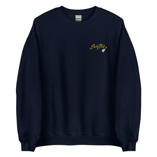 Navy blue crewneck sweatshirt with yellow “Swiftie” script and small guitar graphic on the chest, Taylor Swift inspired fan merch, cozy unisex pullover for concerts and everyday wear