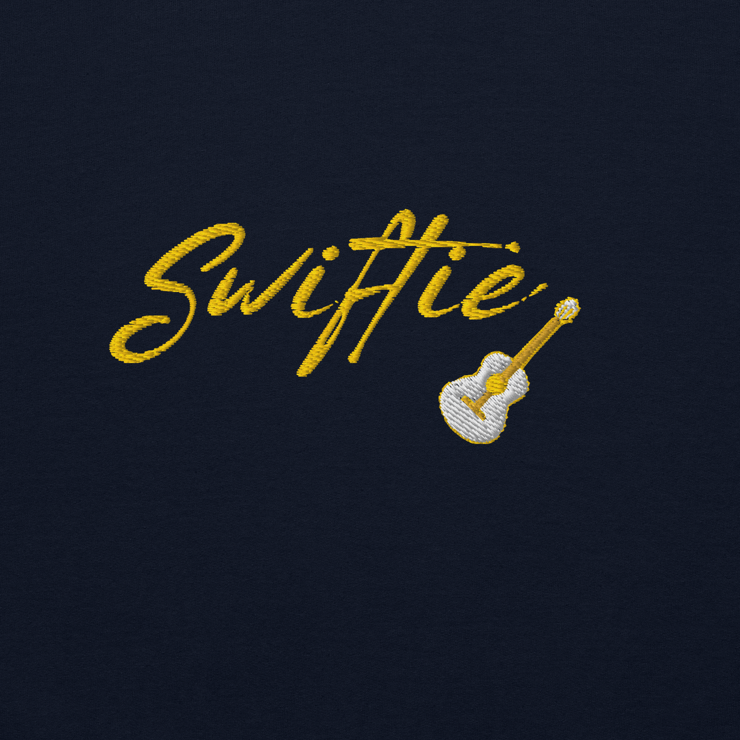 Navy blue crewneck sweatshirt with yellow “Swiftie” script and small guitar graphic on the chest, Taylor Swift inspired fan merch, cozy unisex pullover for concerts and everyday wear