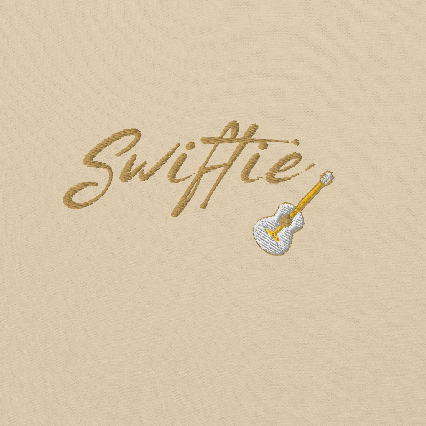 Sand crewneck sweatshirt with yellow “Swiftie” script and small guitar graphic on the chest, Taylor Swift inspired fan merch, cozy unisex pullover for concerts and everyday wear