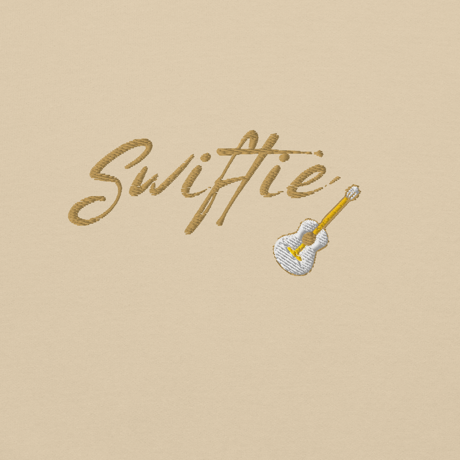Sand crewneck sweatshirt with yellow “Swiftie” script and small guitar graphic on the chest, Taylor Swift inspired fan merch, cozy unisex pullover for concerts and everyday wear