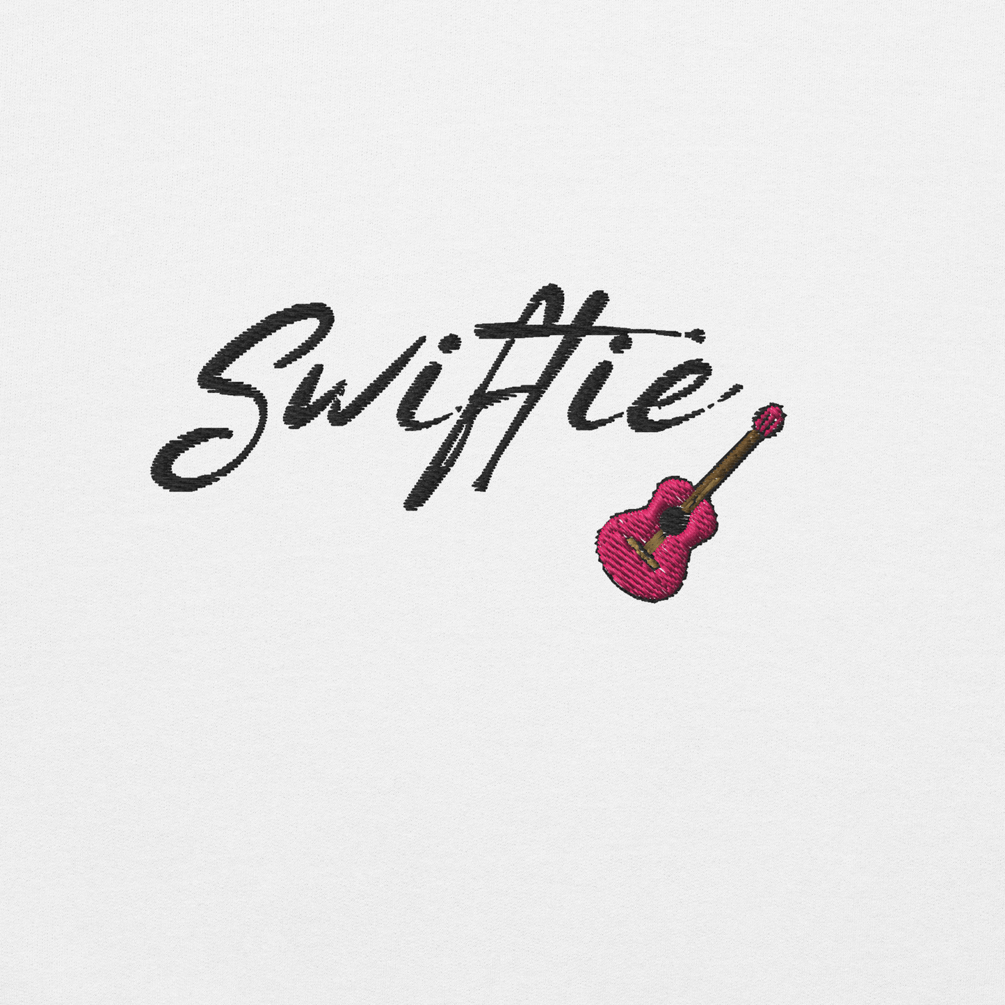 White crewneck sweatshirt with black “Swiftie” script and small guitar graphic on the chest, Taylor Swift inspired fan merch, cozy unisex pullover for concerts and everyday wear