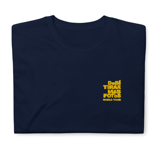 Navy blue crewneck t-shirt featuring small yellow DTMF World Tour graphic and text inspired by Bad Bunny’s DtMF (Debí Tirar Más Fotos) album and global tour merchandise