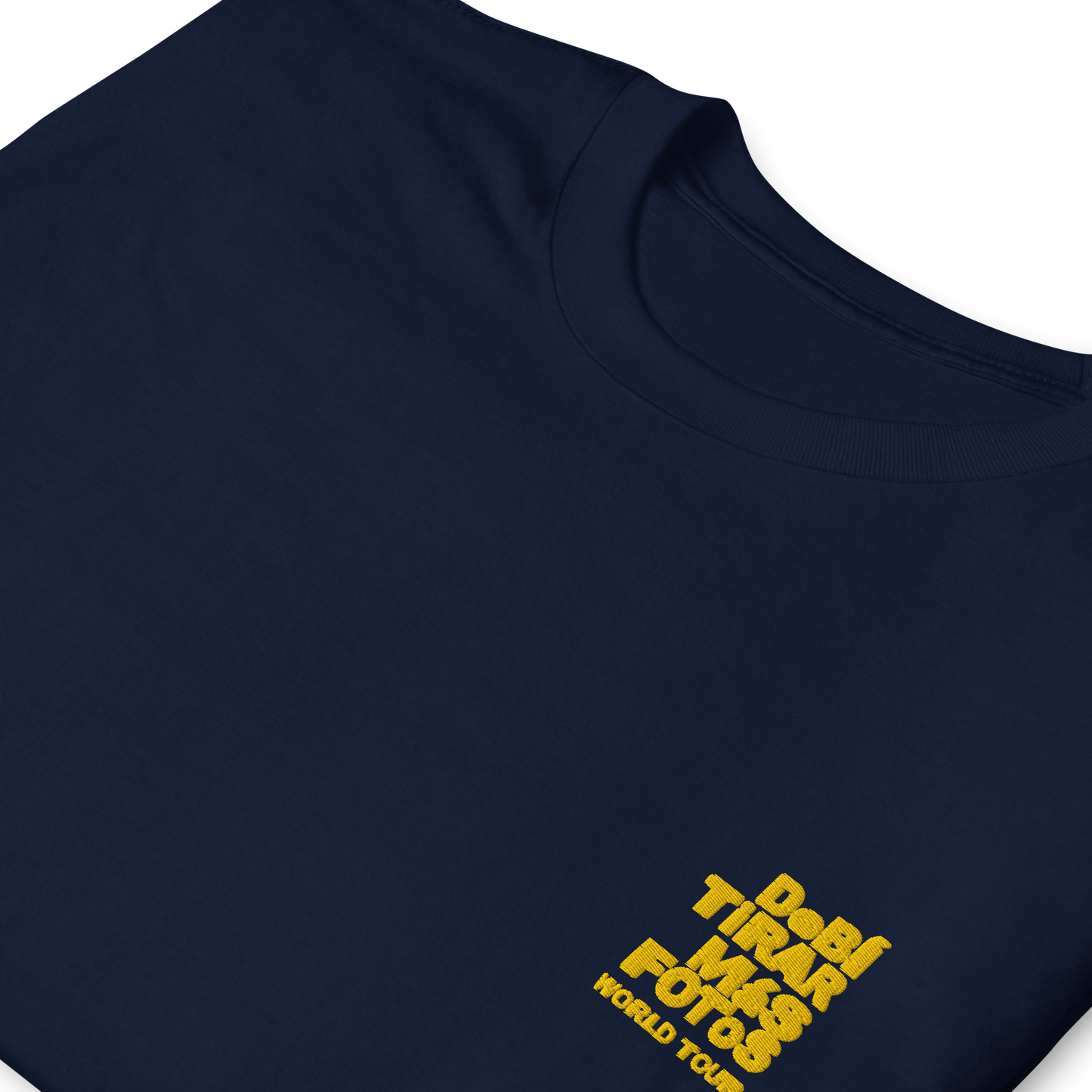 Navy blue crewneck t-shirt featuring small yellow DTMF World Tour graphic and text inspired by Bad Bunny’s DtMF (Debí Tirar Más Fotos) album and global tour merchandise