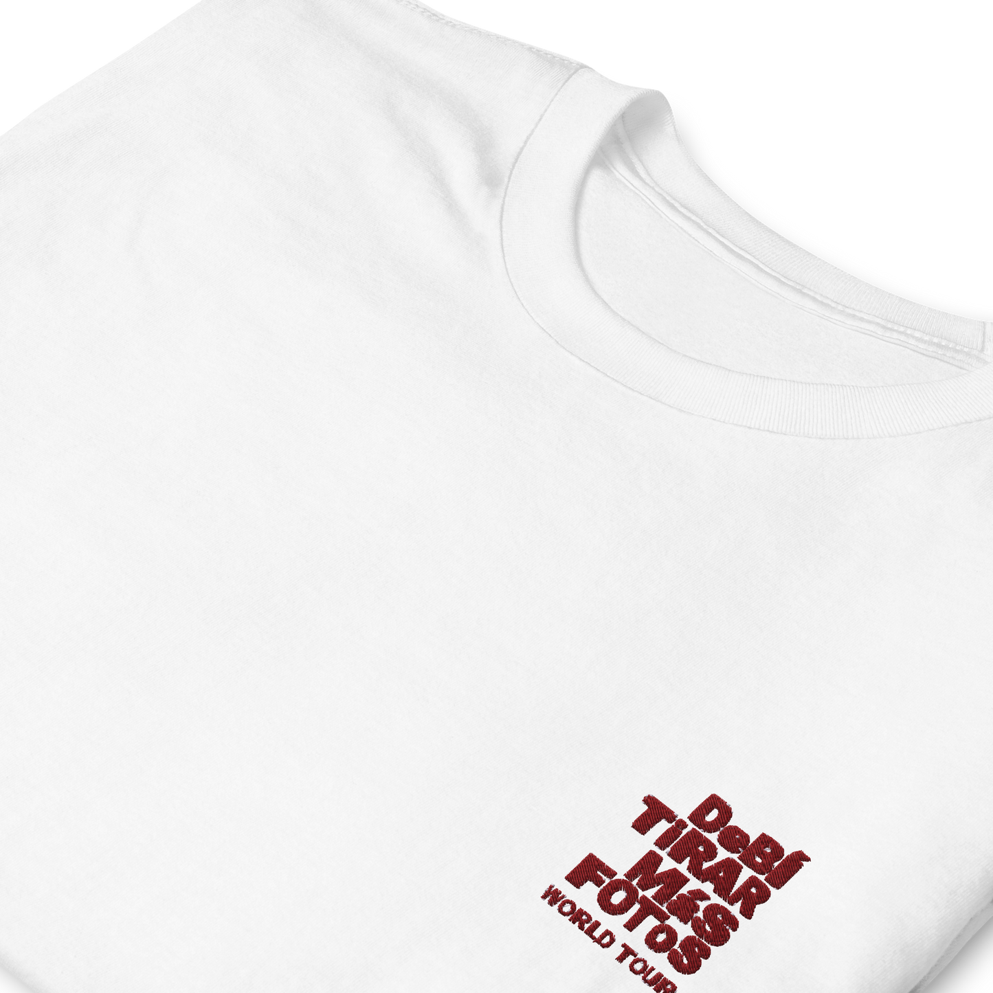 White crewneck t-shirt featuring small red DTMF World Tour graphic and text inspired by Bad Bunny’s DtMF (Debí Tirar Más Fotos) album and global tour merchandise
