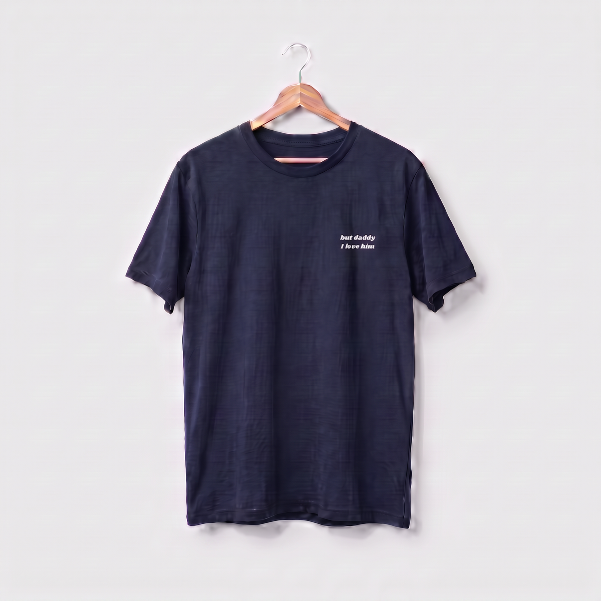 Navy Taylor Swift t-shirt embroidered with 'but daddy I love him' in white script text on the left chest.