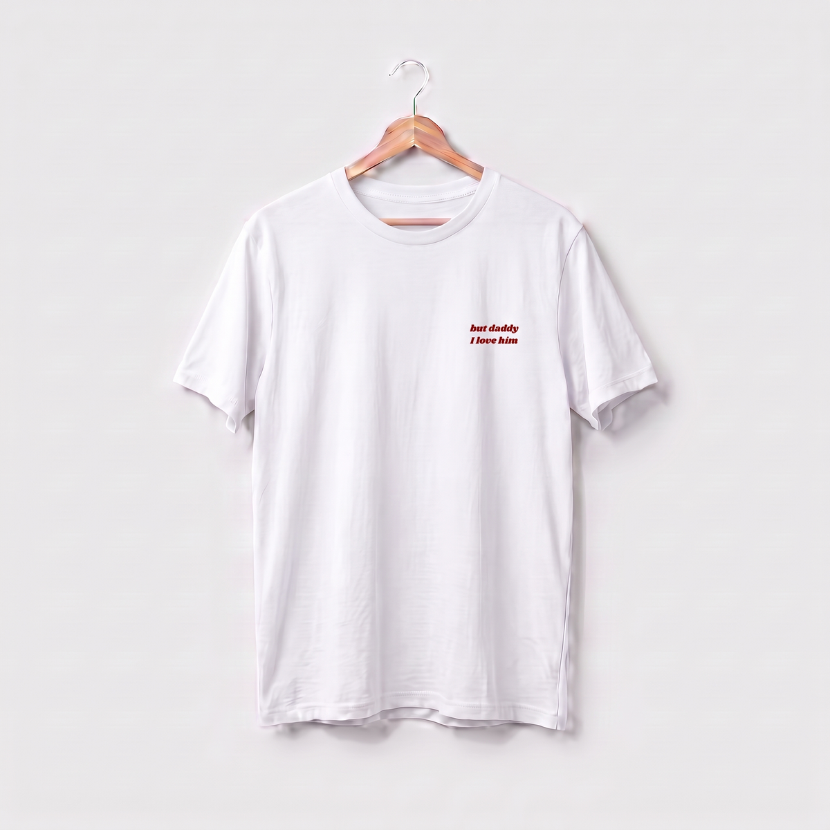 White Taylor Swift t-shirt embroidered with 'but daddy I love him' in red script text on the left chest.