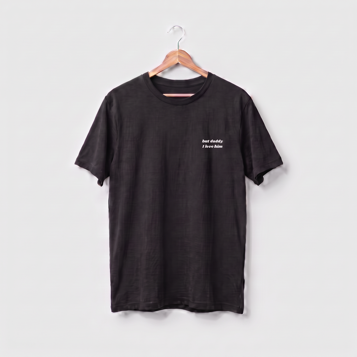 Taylor Swift t-shirt embroidered with 'but daddy I love him' in white script text on the left chest.