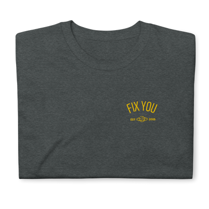 Dark heather minimalist t-shirt featuring yellow “Fix You” typography with subtle graphic detail - Coldplay inspired band merch, aesthetic Coldplay “Fix You” song fan apparel