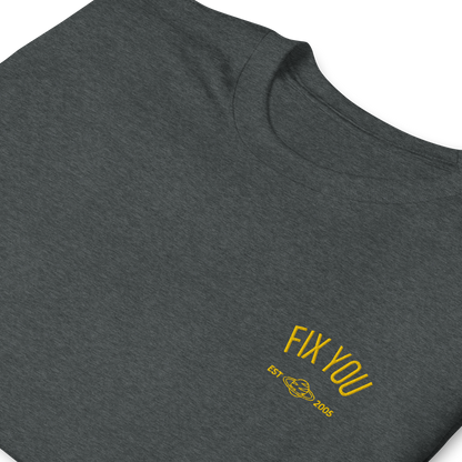 Dark heather minimalist t-shirt featuring yellow “Fix You” typography with subtle graphic detail - Coldplay inspired band merch, aesthetic Coldplay “Fix You” song fan apparel