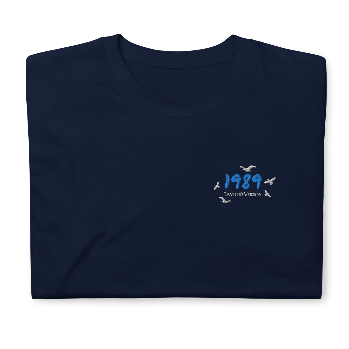 Navy Taylor Swift 1989 (Taylor’s Version) t-shirt featuring a minimalist chest print with blue “1989” lettering and seagull details. Soft unisex tee inspired by Taylor Swift’s 1989 album, perfect for Swifties, concert outfits, and casual pop music streetwear looks