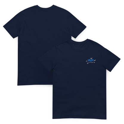 Navy Taylor Swift 1989 (Taylor’s Version) t-shirt featuring a minimalist chest print with blue “1989” lettering and seagull details. Soft unisex tee inspired by Taylor Swift’s 1989 album, perfect for Swifties, concert outfits, and casual pop music streetwear looks