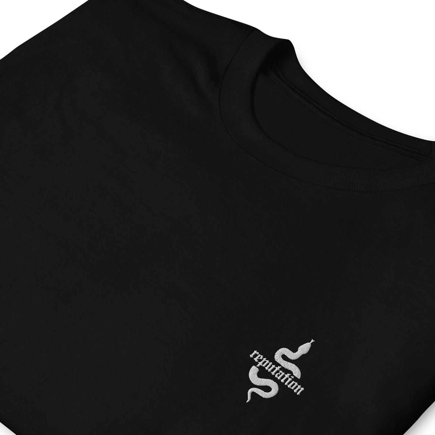 Black Taylor Swift “Reputation” graphic t-shirt featuring iconic bold white snake logo inspired by the Reputation album era, official fan merch for Swifties