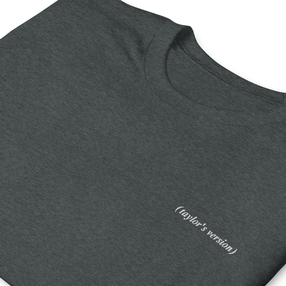 Close-up of a dark heather  t-shirt with "(taylor's version)" embroidered in script text